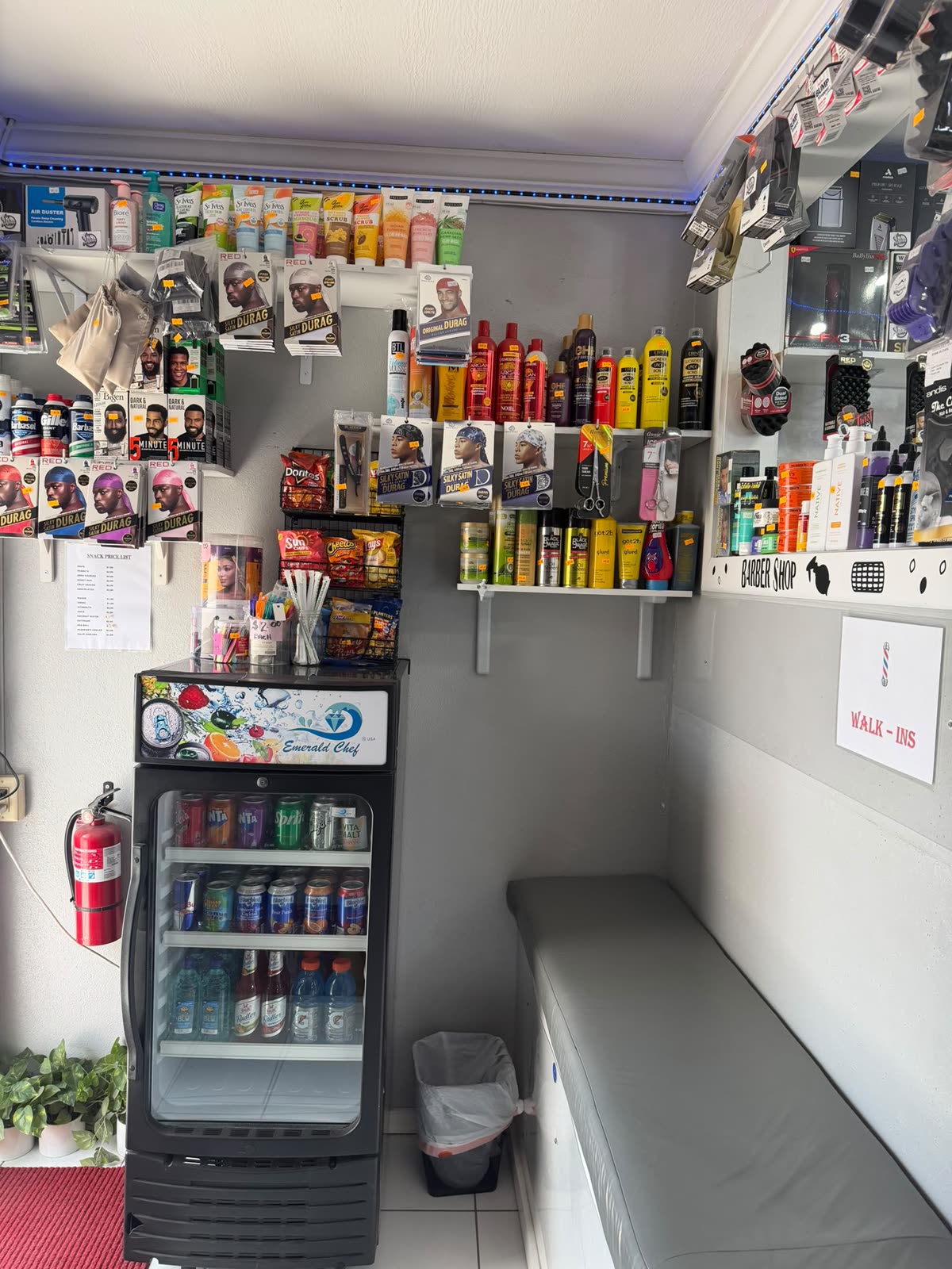 The snack corner with drinks fridge and product shelves